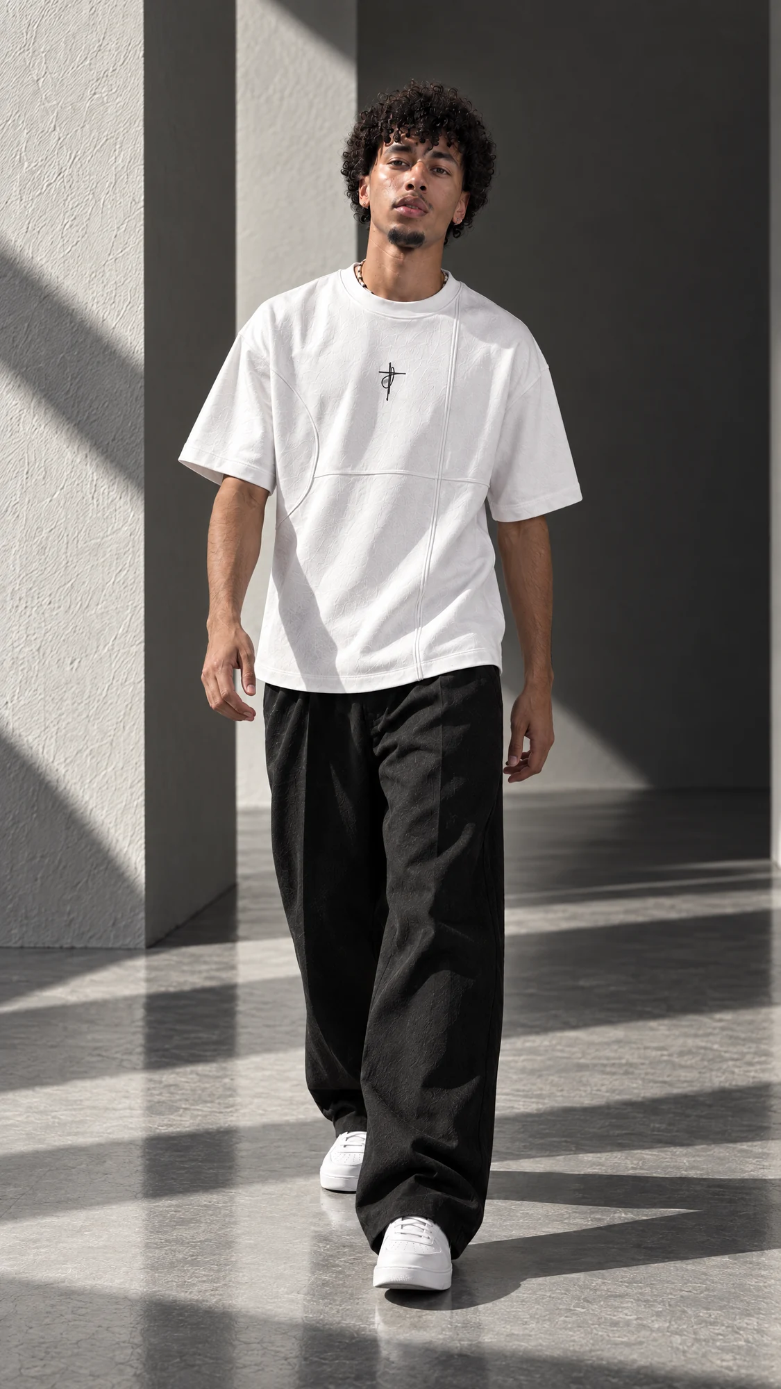 White XAUNI oversized tee styled with relaxed black trousers